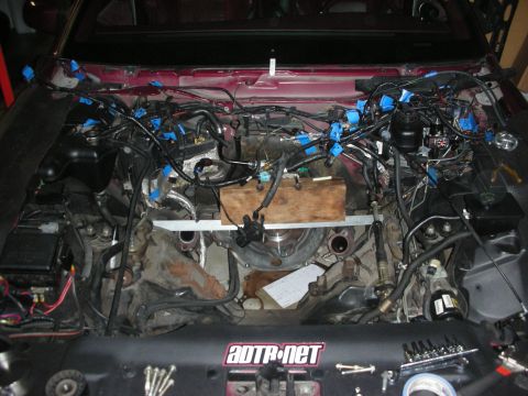 1992 Ford Crown Victoria - The engine bay is filled with a complex wiring harness, suggesting a recent repair or modification.