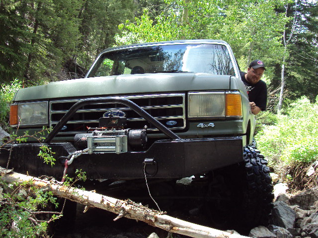 Green Ford Bronco with winch and bull bar, front view