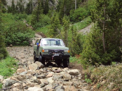 1989 Ford Bronco - This 1989 Ford Bronco navigates a challenging rocky terrain on a mountain trail.