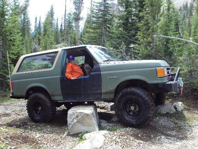 Green 1989 Ford Bronco 4x4 on rocky trail