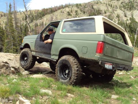 1989 Ford Bronco - This 1989 Ford Bronco is navigating a rocky off-road trail with a driver inside.