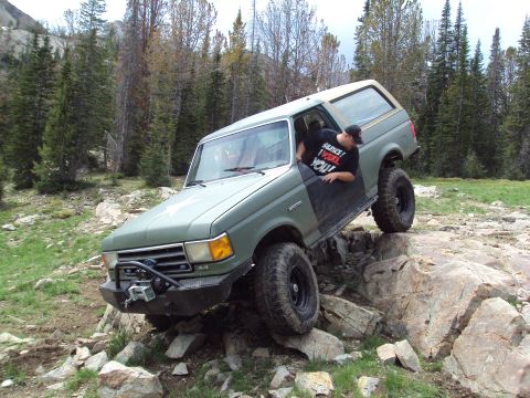 1989 Ford Bronco - This modified Ford Bronco navigates a challenging rocky terrain, its off-road capabilities.