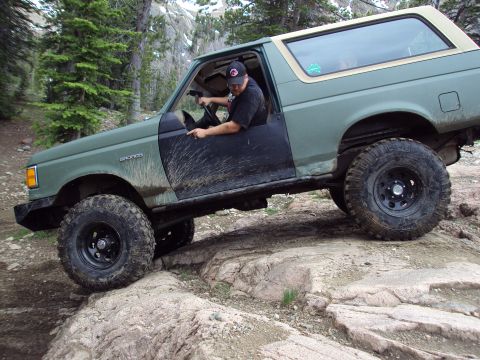 1989 Ford Bronco - This 1989 Ford Bronco navigates a rocky trail with mud splattered on its doors.