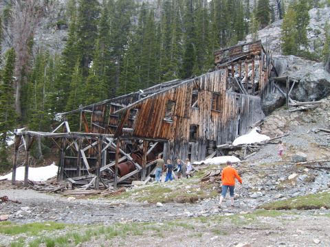 1989 Ford Bronco - People explore the ruins of an old wooden mine structure on a mountainside.