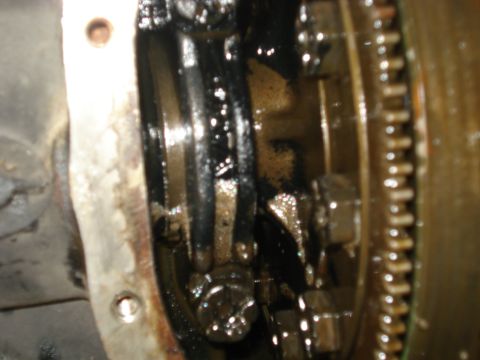 1988 Ford Bronco - Internal view of a vehicle's differential gears and housing, covered in grease.