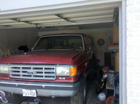 1988 Ford Bronco - Front view of a red 1988 Ford Bronco parked inside a garage.