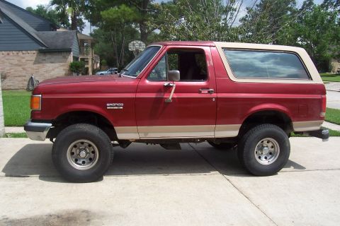1988 Ford Bronco - This 1988 Ford Bronco is shown from the side, its distinctive red and tan color scheme.