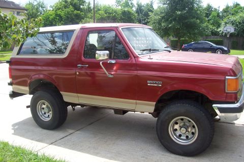 1988 Ford Bronco - This 1988 Ford Bronco is shown from the side, with a tan top and trim.
