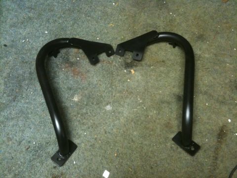 1995 Ford Bronco - Pair of black metal tube steps, likely for an SUV or truck, shown before installation.