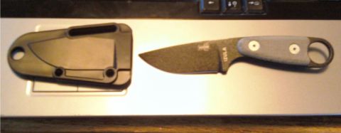 1984 Ford Bronco - A knife and its sheath are displayed on a textured surface, with a website address visible at the bottom.