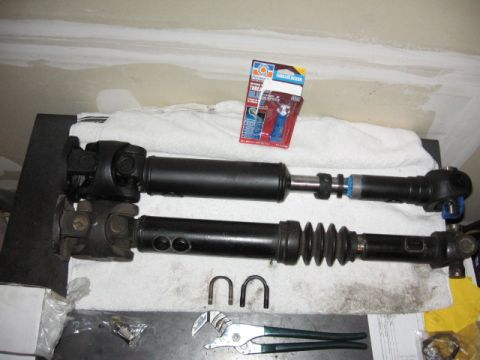 1995 Ford Bronco - Two driveshafts are laid out with a tube of threadlocker and a pair of pliers, suggesting a repair or upgrade.