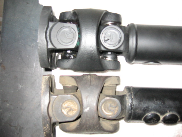 Two driveshaft U-joints compared, top cleaner and bottom rusted