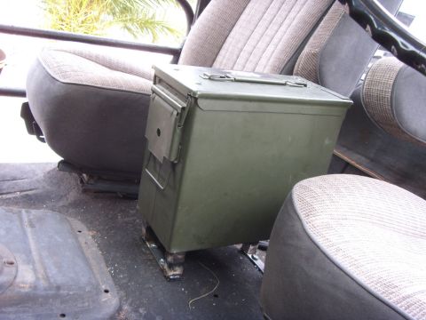 1978 Ford Bronco - An olive drab ammo can serves as a console between the seats of this vehicle, which features patterned upholstery and a roll bar.