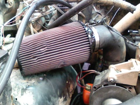 1990 Ford Bronco - Close-up of an engine bay with a prominent air filter and intake system.