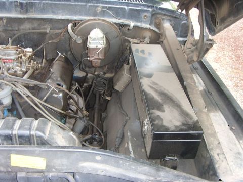 1978 Ford Bronco - Engine bay view of a 1978 Ford Bronco, showing the carburetor, brake booster, and other engine components.