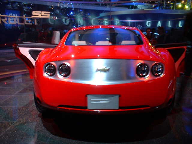 Red sports car rear with quad taillights and silver accent panel