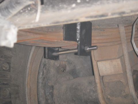 1991 Ford Bronco - Undercarriage view of a vehicle's suspension system with a custom bracket installed.