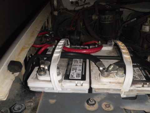 1991 Ford Bronco - Engine bay view showing dual batteries and red cabling. The registry claims this is a 1991 Ford Bronco, but the image does not provide enou…