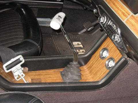 1968 Shelby GT500 - The interior of a 1968 Shelby GT500 shows woodgrain accents and a floor-mounted shifter.
