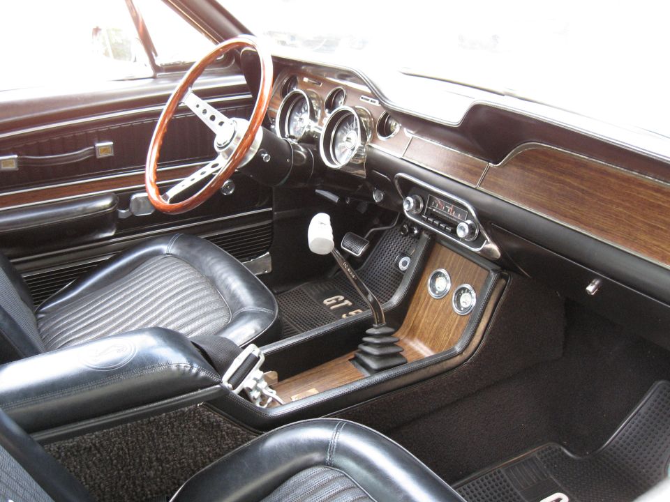 1968 Shelby GT500 interior showing wood grain dash, steering wheel, and shifter