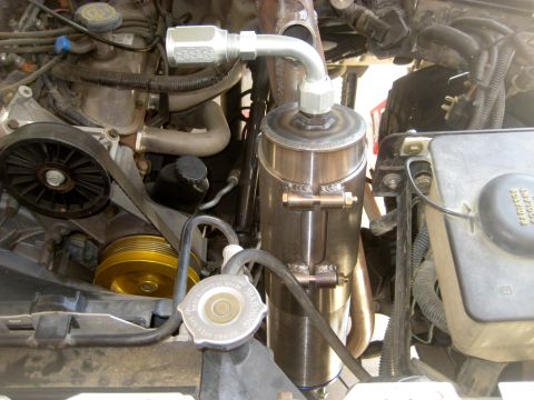 1996 Ford Bronco - Close-up view of the engine bay, highlighting a custom oil catch can and various engine components.