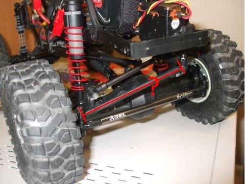 1996 Ford Bronco - Close-up view of a remote control car's suspension system and tires.