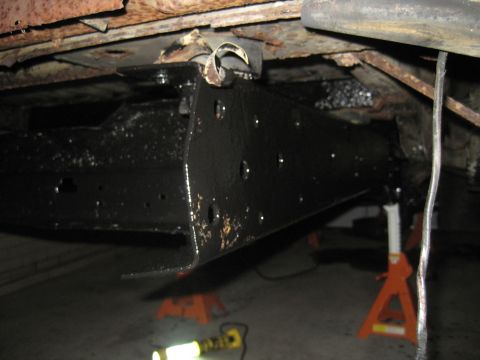 1979 Ford Bronco - The underside of a vehicle is shown, with focus on the frame and suspension components, which appear to be recently painted.