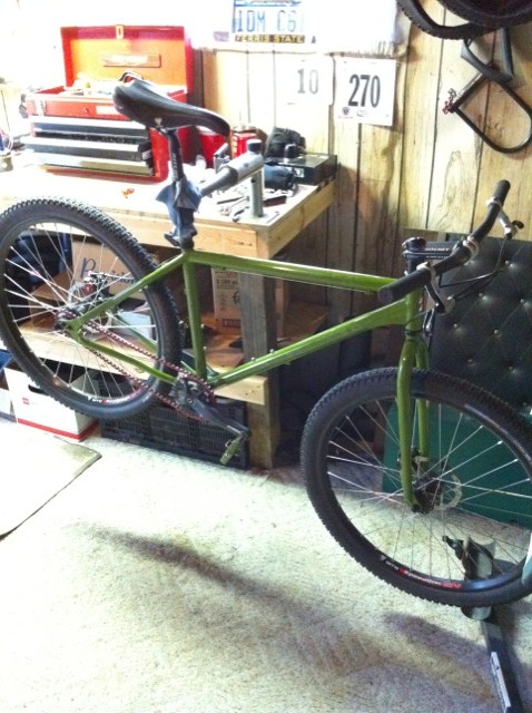 2010 Hyundai Genesis - Green bicycle frame being worked on at a workbench with tools and a toolbox visible.