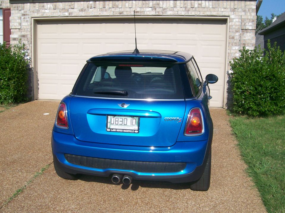 Rear view of blue MINI Cooper S hatchback with black roof on a driveway
