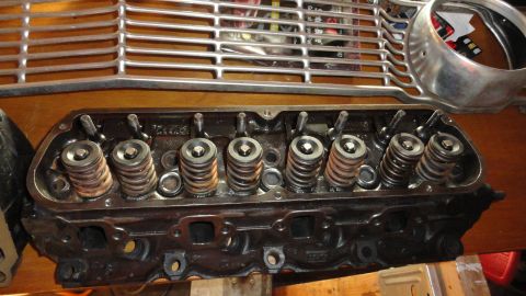 1964 Ford Fairlane - Close-up of a Ford V8 engine cylinder head with valve springs and a chrome grille piece.