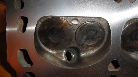 1964 Ford Fairlane - Engine cylinder head showing two valve openings and a threaded spark plug hole.