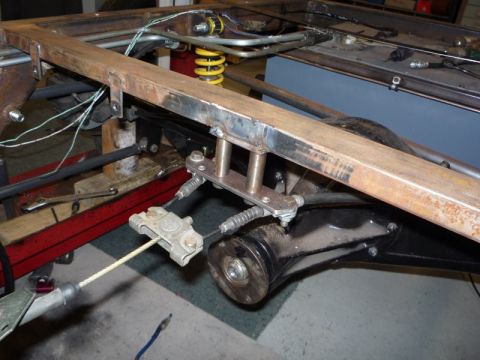 1969 MINI Cooper - Close-up view of the undercarriage of a vehicle, focusing on suspension and brake components.
