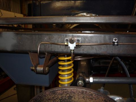 1969 MINI Cooper - Close-up of a proportioning valve and brake line assembly on a custom vehicle frame.