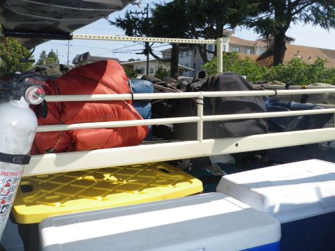 1991 Ford Bronco - Fire extinguisher and camping gear loaded in the bed of a vehicle.