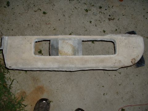 1994 GMC Suburban - Sun visor from a car interior, showing two openings, resting on a concrete surface.