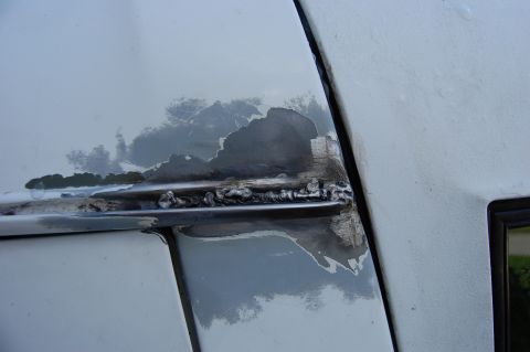 1994 Ford Bronco - The photo shows significant rust and body damage, indicating repair work on a vehicle's exterior.