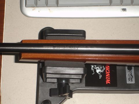 1989 Ford Bronco - A Savage .22 rifle is shown resting on a stand, with a Winchester sticker on the side.