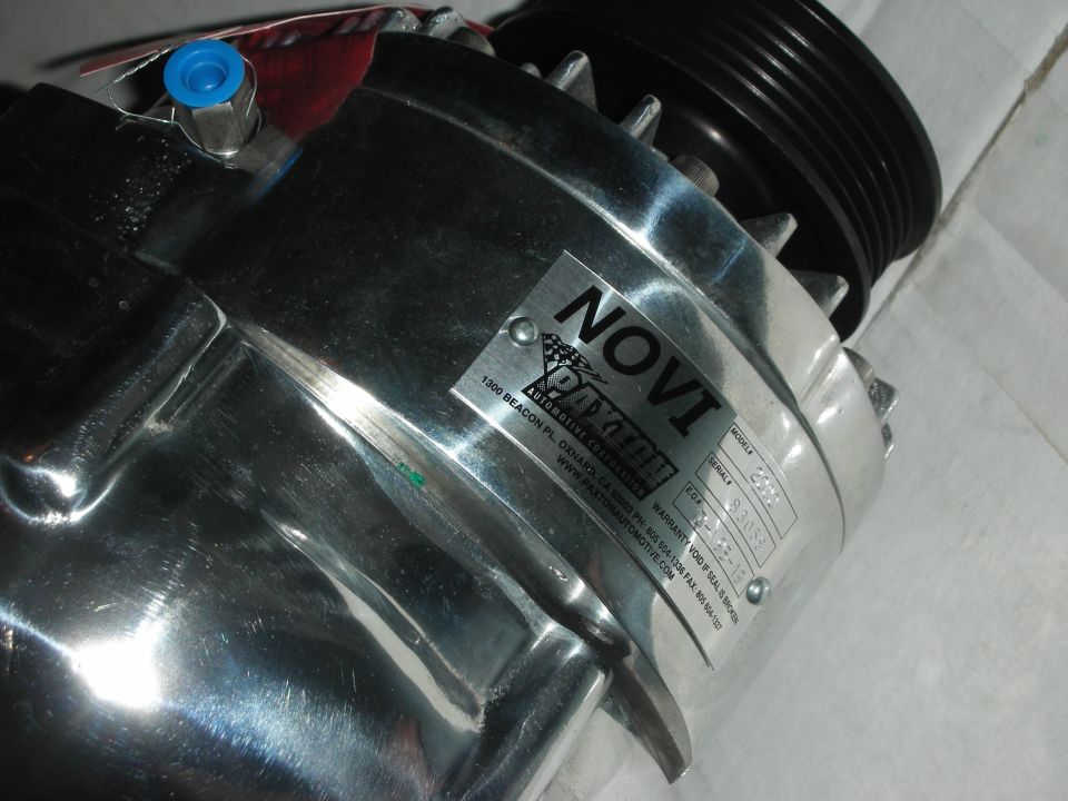 Chrome Paxton Novi supercharger with a black pulley on top. Label reads 'NOVI Paxton Automotive Components'