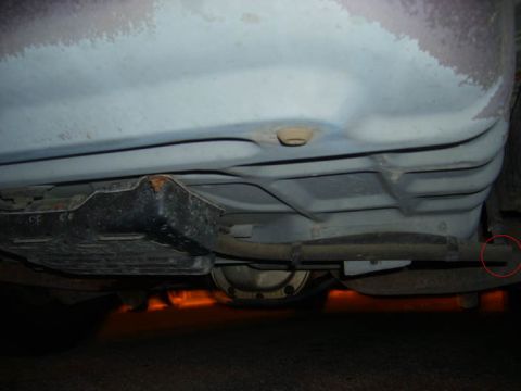 2002 Ford Crown Victoria - The underside of a vehicle is shown, with a focus on the fuel tank and exhaust system.