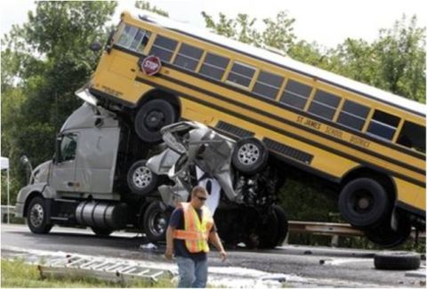 1972 Ford Ranchero - Highway crash scene showing a yellow St. James School District school bus riding up and over a crushed silver passenger car and the front o…