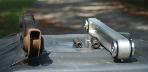 1976 Ford Ranchero - Comparison of old and new suspension control arms, along with mounting bolts.