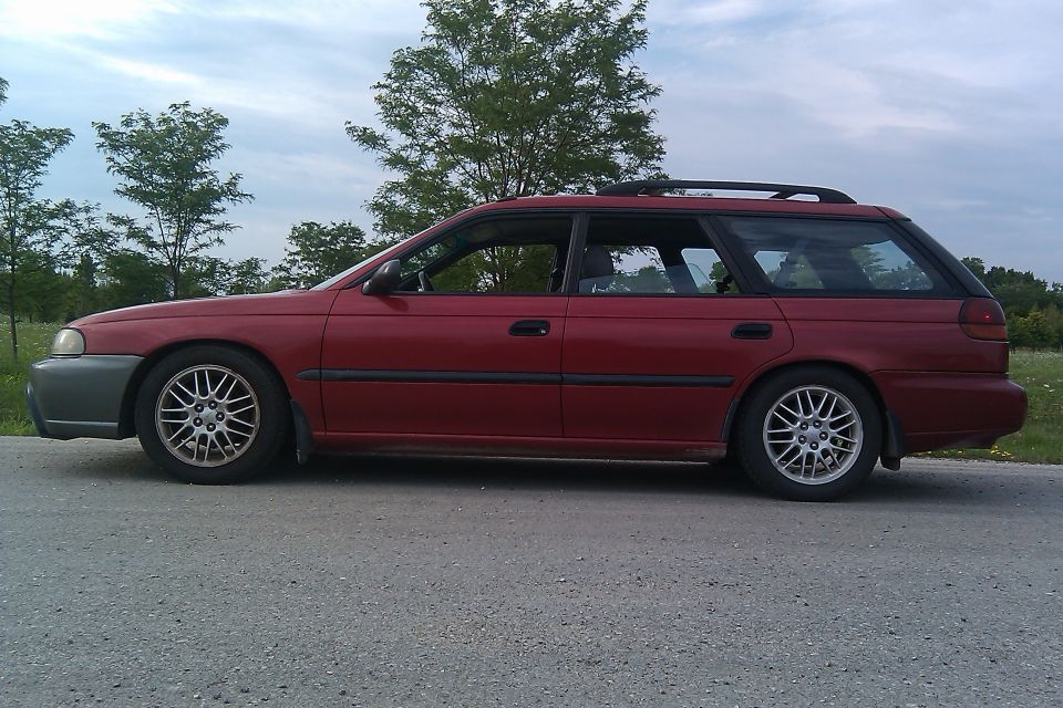 Side view of a red 1998 Subaru Legacy station wagon
