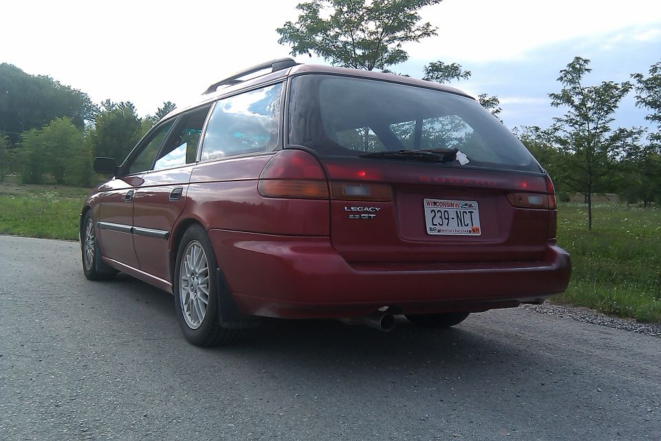 Red 1998 Subaru Legacy wagon rear view with license plate 239-NCT