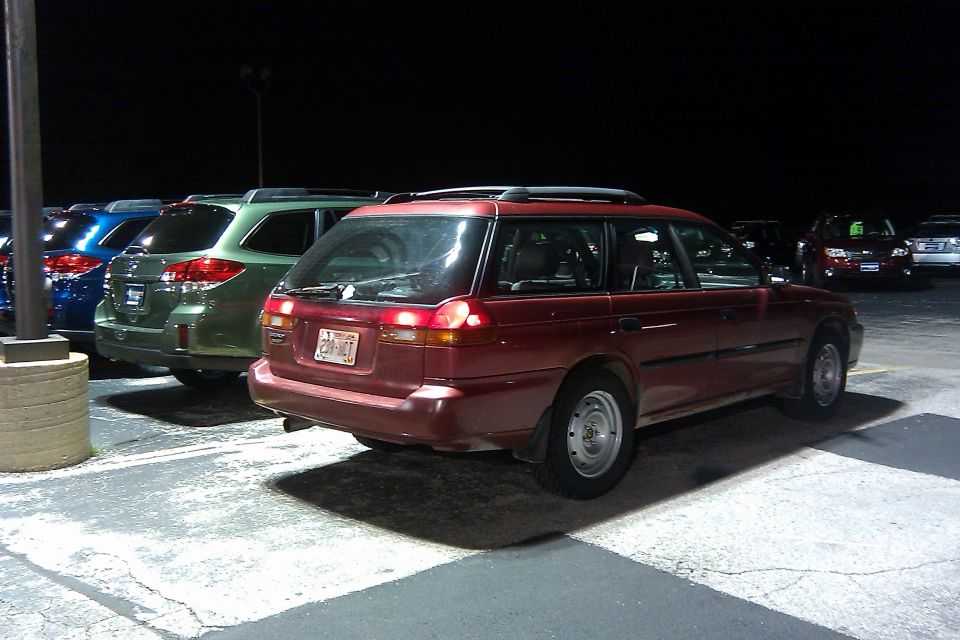 red station wagon parked at night, license plate 230-MCT