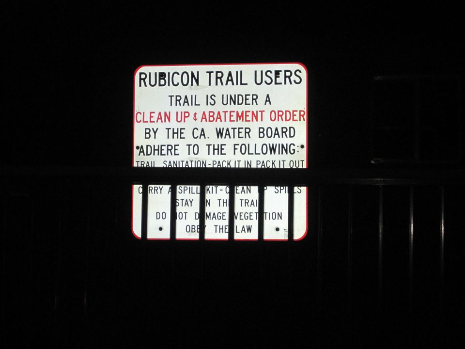 Illuminated Rubicon Trail cleanup and abatement order sign at night