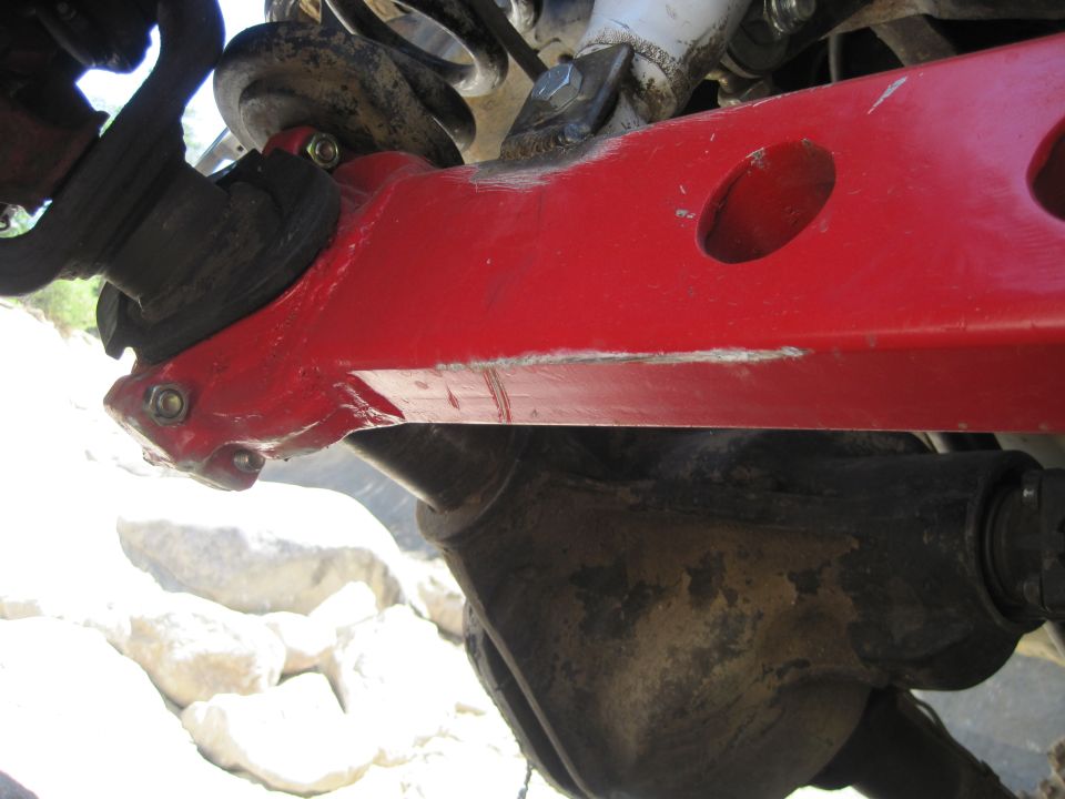 Close-up of red suspension arm and differential on an off-road vehicle