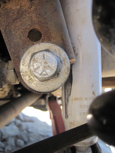 1989 Ford Bronco - A close-up view of a vehicle's suspension components, including a shock absorber and mounting hardware.