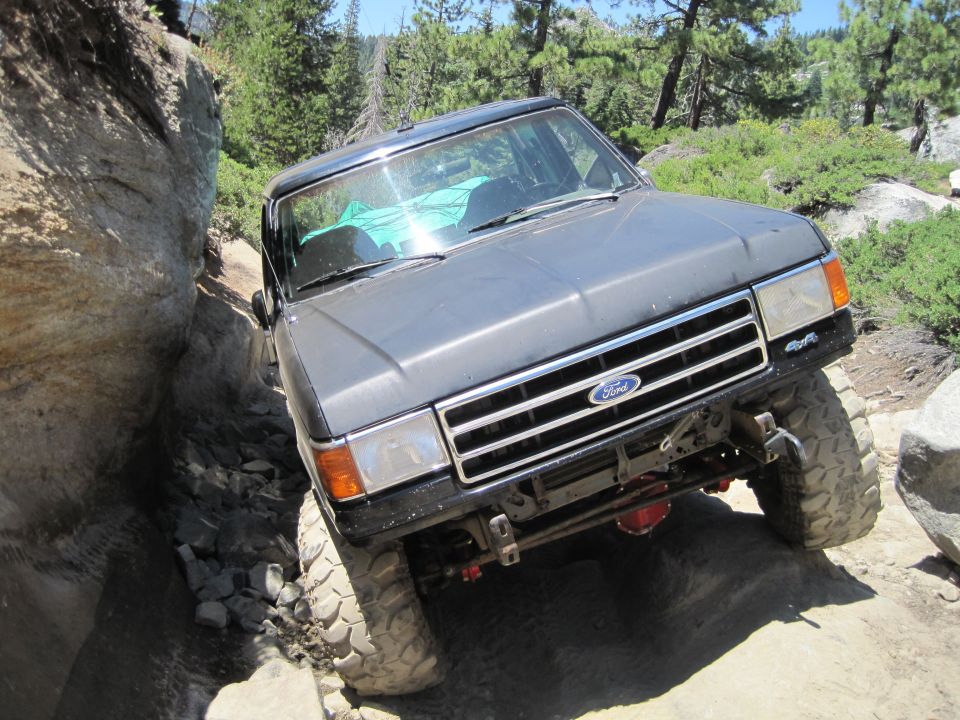 Gray 1989 Ford Bronco navigating a rocky trail