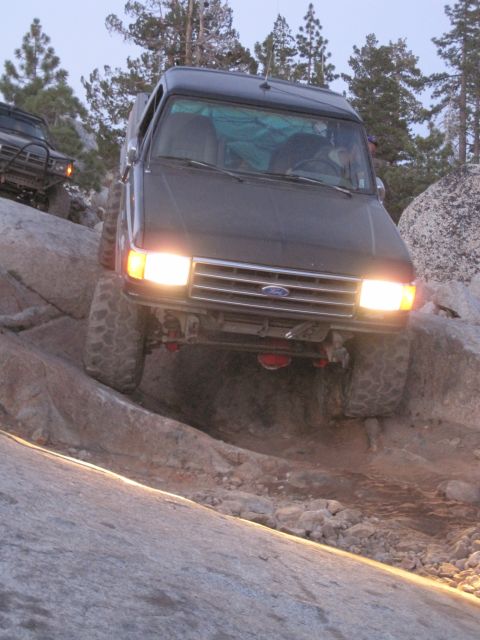 1989 Ford Bronco - This 1989 Ford Bronco navigates a rocky trail with its headlights illuminated.