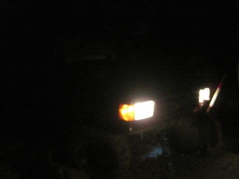 1989 Ford Bronco - A truck's front lighting is visible in the dark.